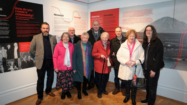 A group of older people who founded Ireland’s first urban Gaeltacht at Shaws Road in Belfast with two representatives from the Ulster Museum flanking them.