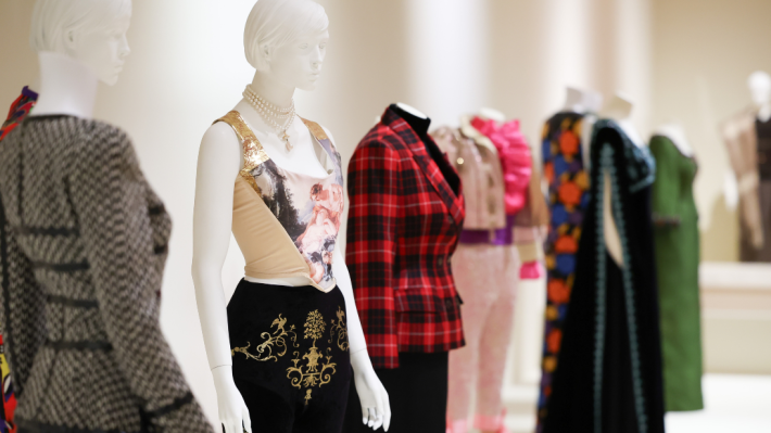 A row of white mannequins modelling garments in the Ashes to Fashion exhibition at Ulster Museum