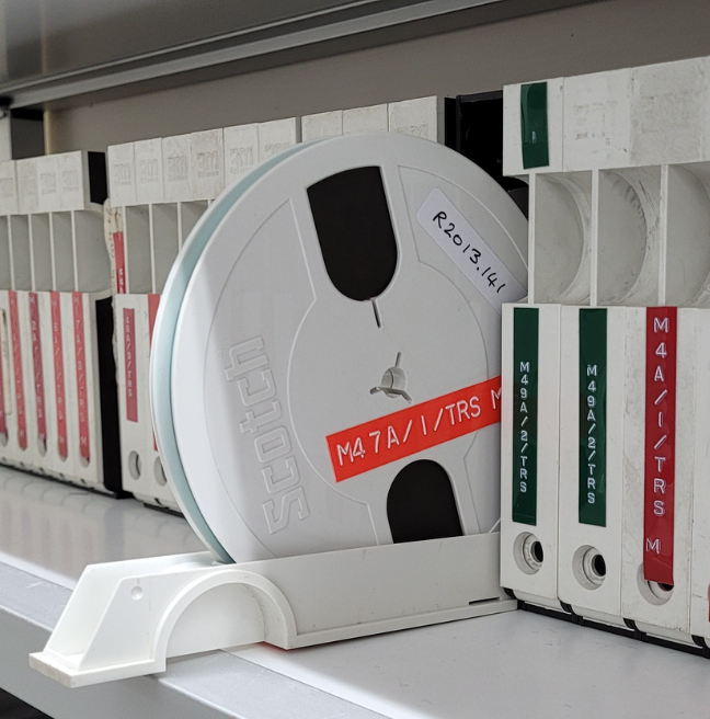 A shelf in a sound archive showing a sound reel.
