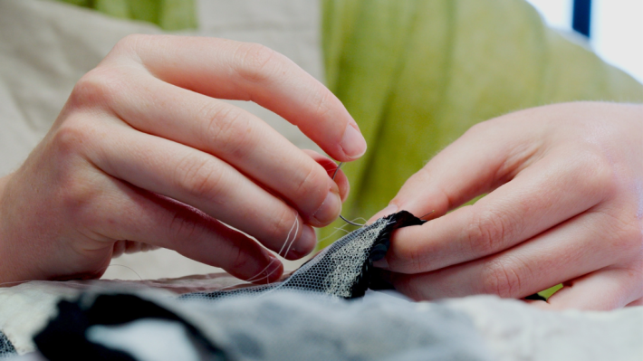 Stitches being made to the gelatine sequin dress