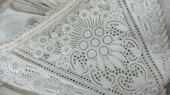 Detail on the yoke of a white christening robe, late 1800s 