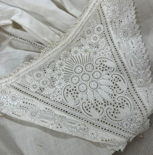 Detail on the yoke of a white christening robe, late 1800s