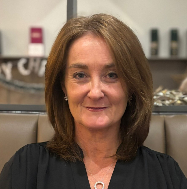 A headshot of a woman looking at the camera.