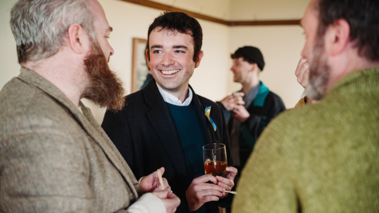 An image of three men conversing in the ulster folk museum