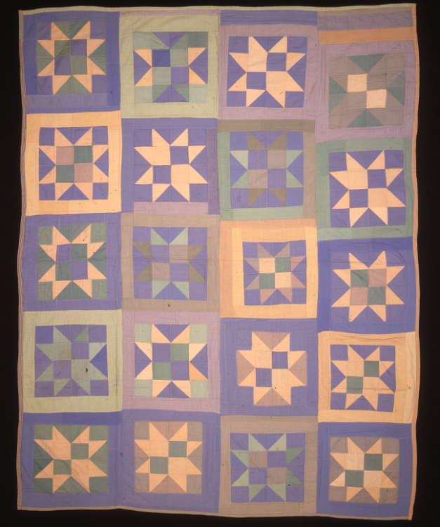 A colourful quilt with purples, blues, and oranges in squares with different patterns. 