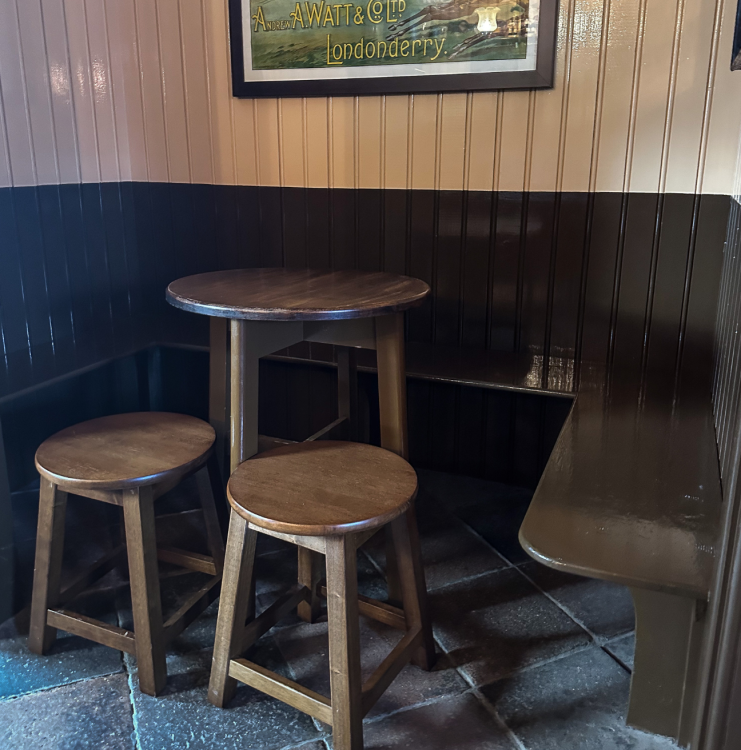 A pub nook with a wooden table and chairs.
