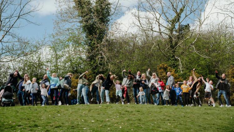 a group of people throwing eggs as part of a egg rolling Easter event 