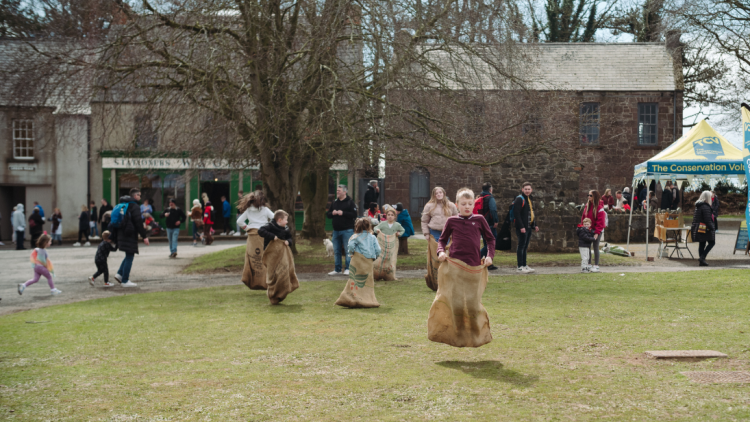 children playing games in a bag race 