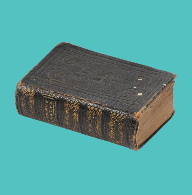 Small, used Bible on a turquoise background