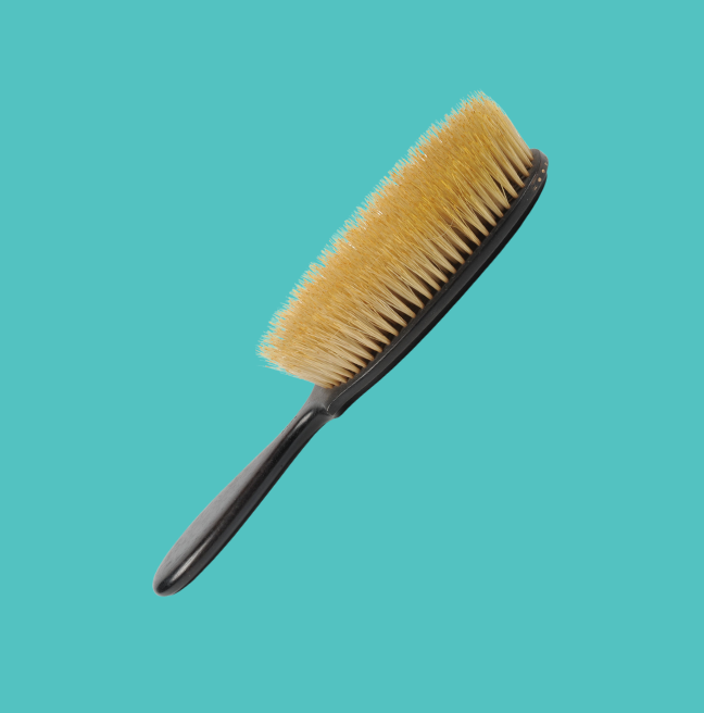 Hair brush on a turquoise background