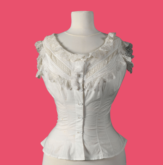 White corset on a mannequin, pink background