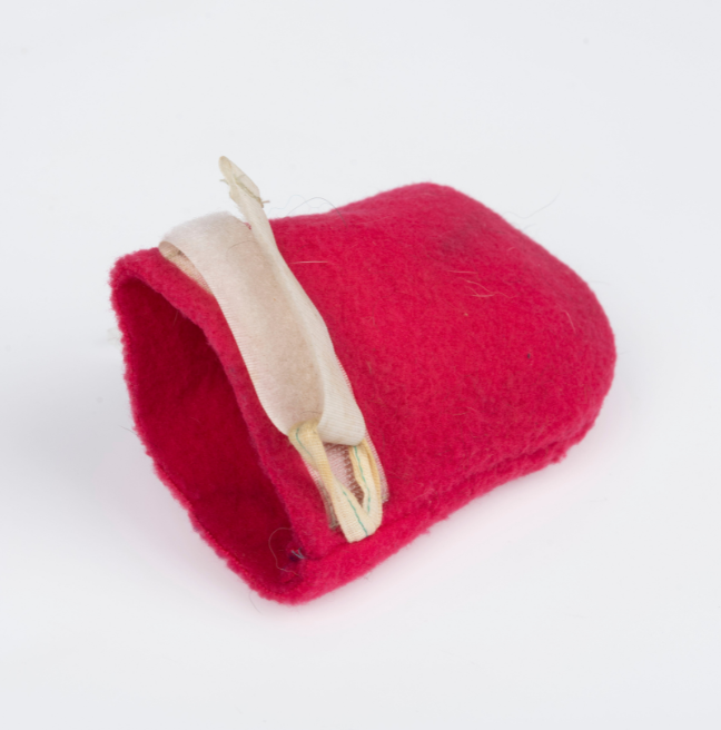 A red dog mitten with a white clasp.