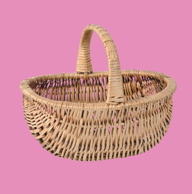 Wicker basket on a pink background