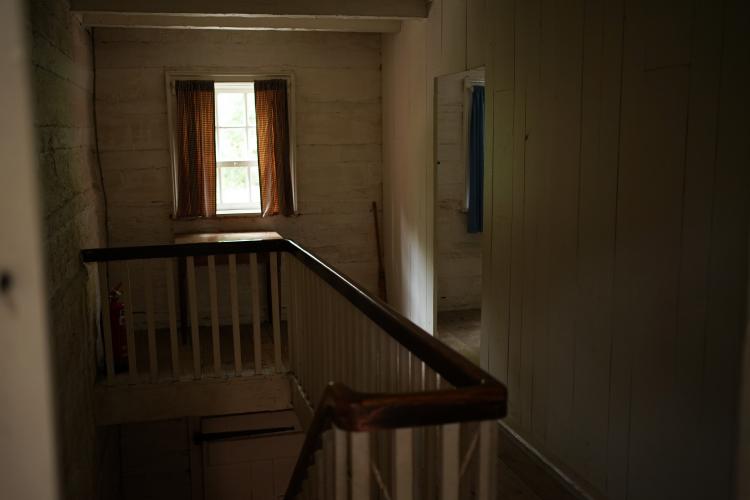 The upstair hall of a log farmhouse. It is quite small.