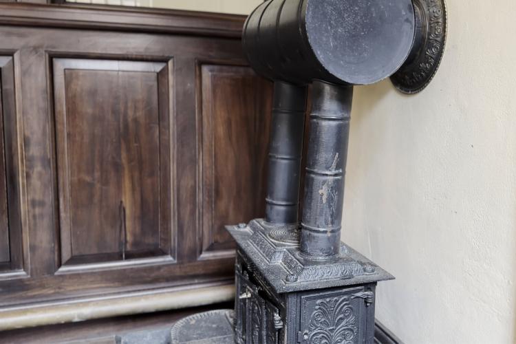 An image of an older fashioned heater made out of iron. 