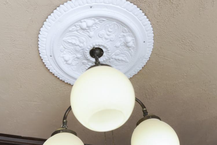 An image of a plaster decoration around a ceiling light.