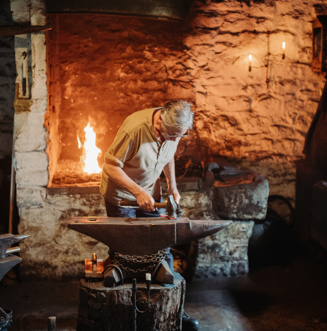 A blacksmith at the Forge in the folk museum 