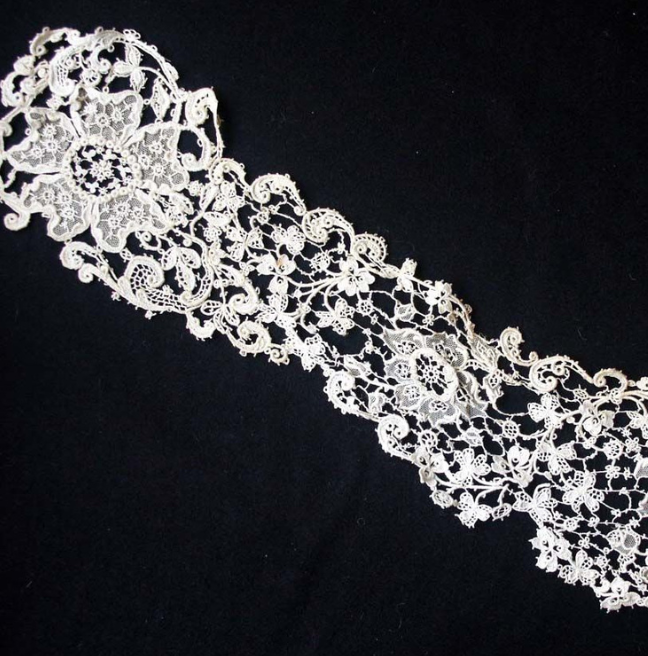 A strip of lace with larger flower designs.