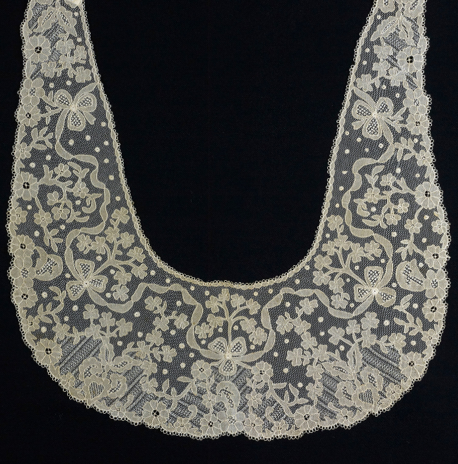 A lace collar with intricate design feature flowers. 