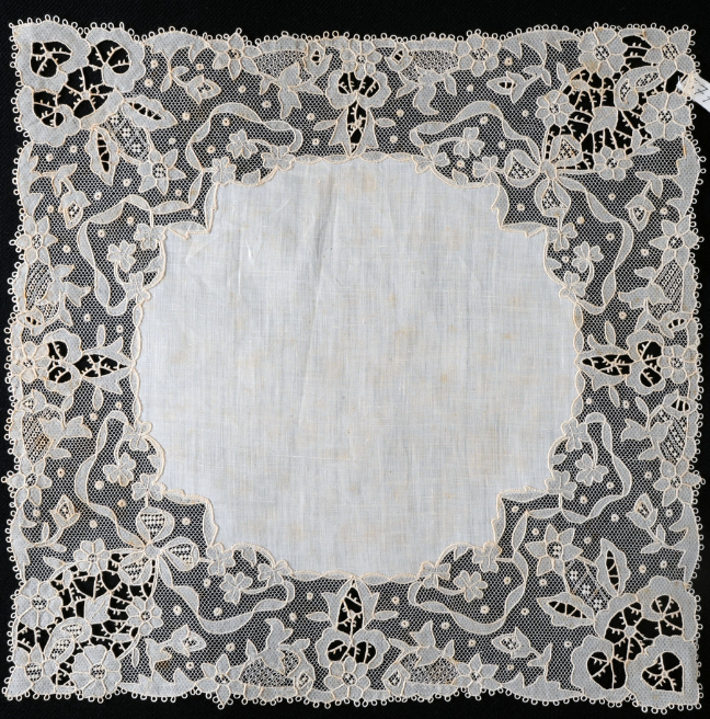 A handkerchief with a large lace border. 