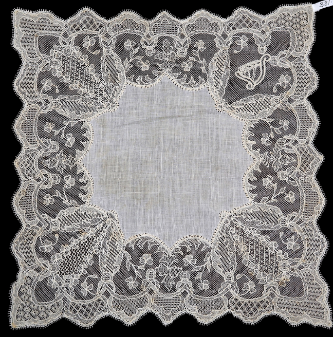 A delicate lace handkerchief with intricate, small designs. 