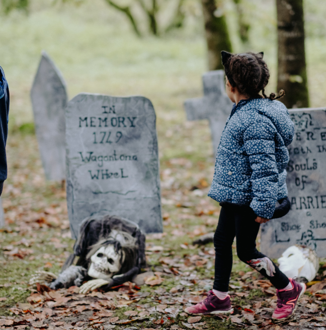 a child looking at  Halloween decorations at the folk park 