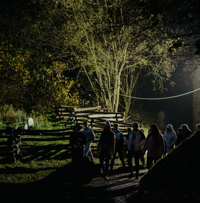 a group walking on a torchlight tour