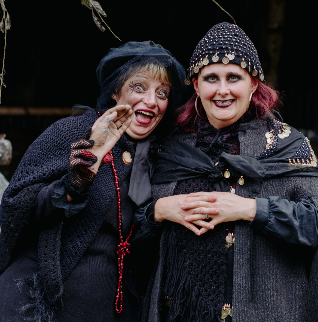 Two women dressed in costume for halloween at the folk park 