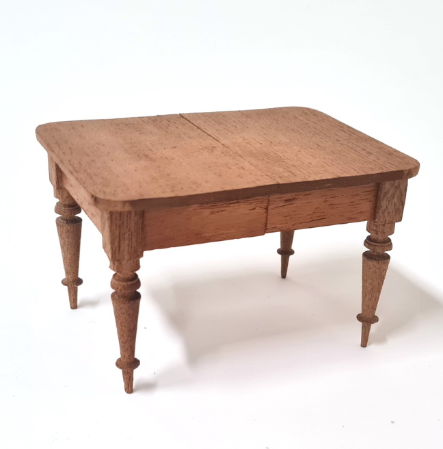 A wooden table for a dolls' house. It is expertly made.