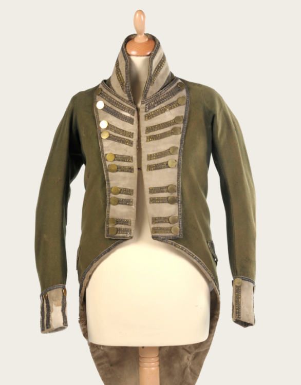 A men's green coat dating from the late 1700s to early 1800s.