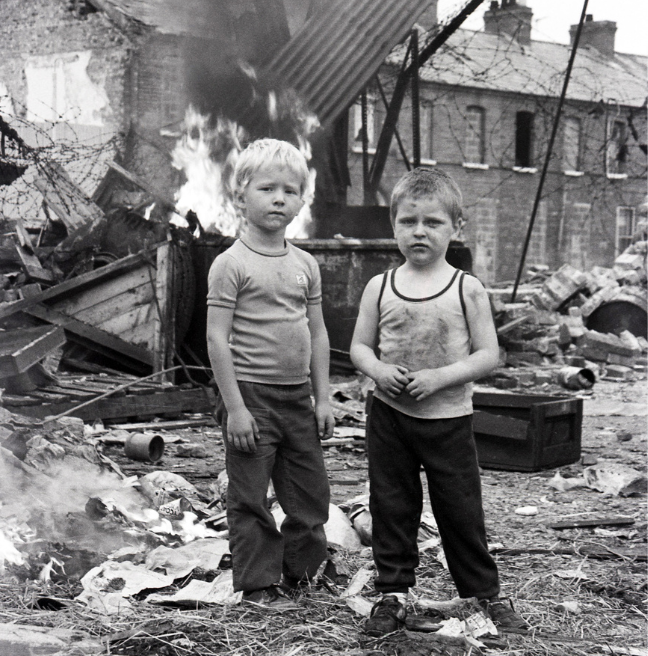 Frankie Quinn photography - black and white image of two kids in a destruction area