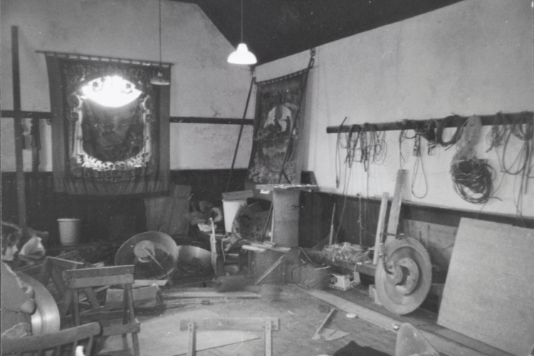 A black and white image of an Orange Order Hall. A banner hangs on the wall.