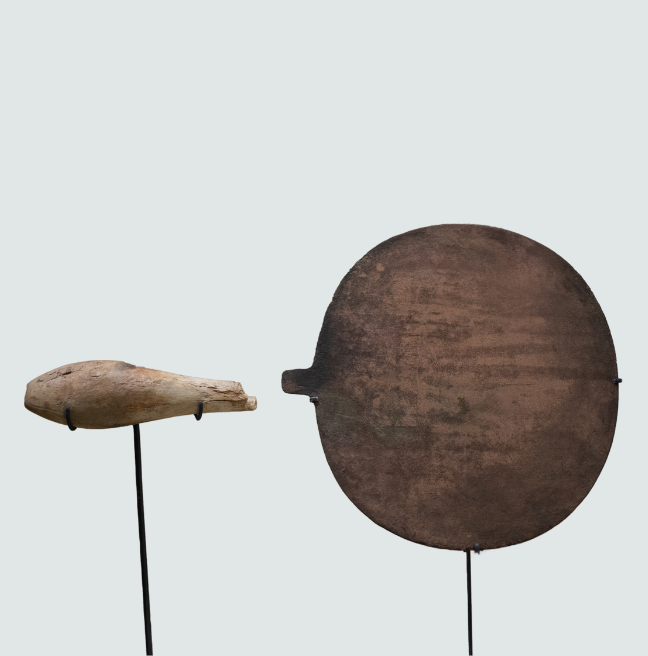 A handle and round paddle, the remains of a handheld mirror.