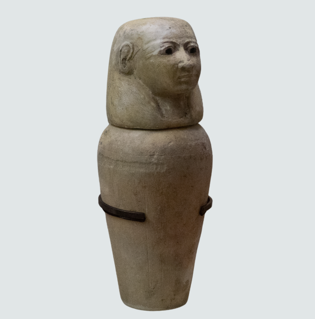A canopic jar with a jar lid in the likeness of an Egyptian God. 