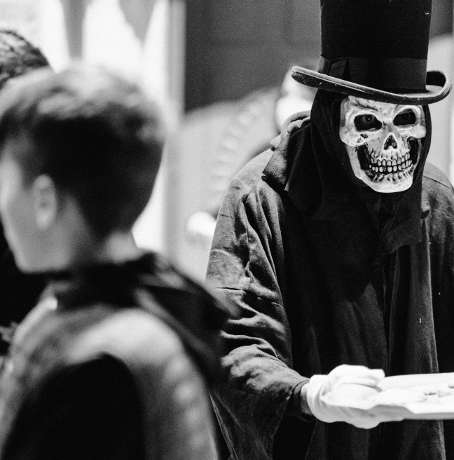 A black and white image of a person in a skeleton costume