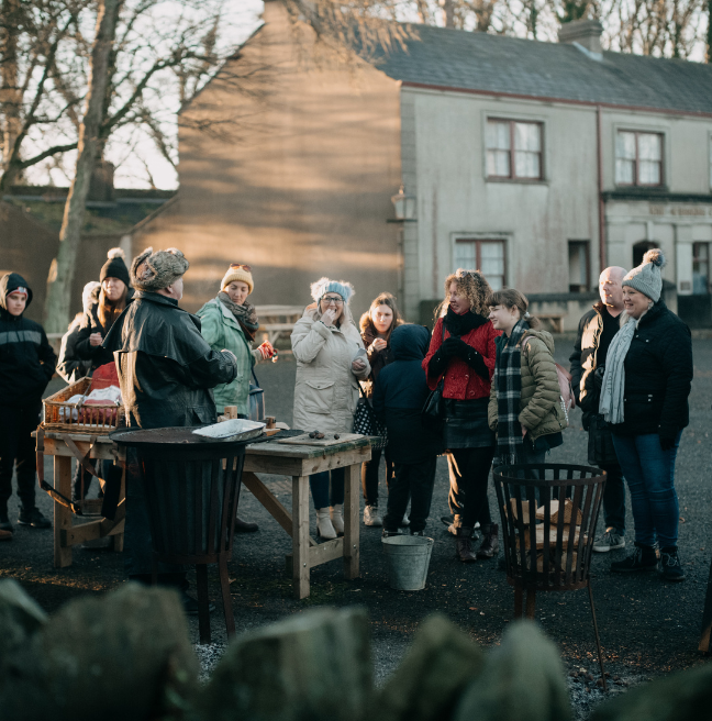 A group of people sampling chestnuts