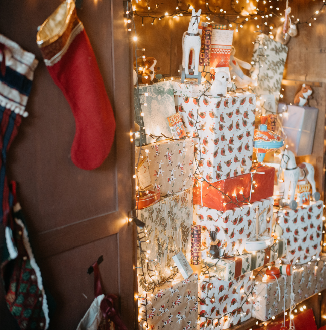 A pile of presents wrapped in white and red paper