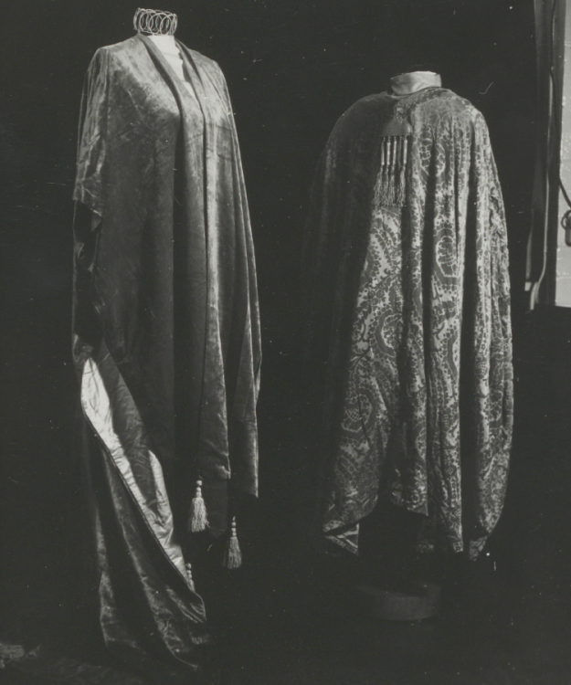 A black and white photograph of a long velvet evening wrap.