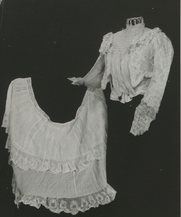 A black and white photograph of two lace flounce shirts