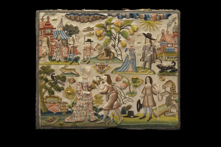 The top of an intricately embroidered box. The scenes depicted are a small village scene, showing a man raising his hat to a man and lady; a man with a horse sitting under a tree; a man and a lady holding hands; a badger or a black and white dog; a man holding the reins of his horses or camels, as they drink water; and a scene at a well, where a woman holds a jug and tips it into the mouth of a man. There are other designs filling spaces, including a rabbit, snail, strawberries, a moth, a pear tree, the sun