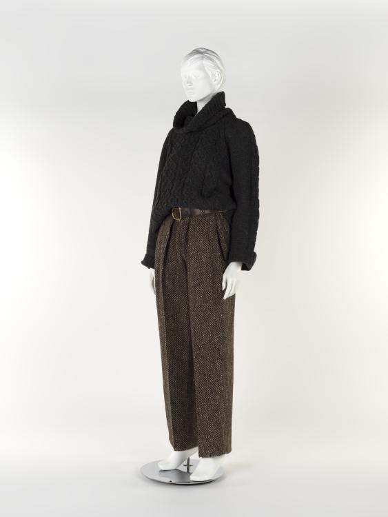 An outfit made from Irish materials. A rich, dark brown turtle neck with a pair of long tweed trousers and a brown belt.