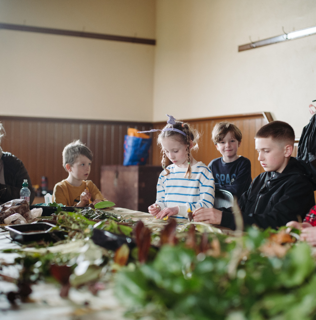 a group of children doing crafts at a table