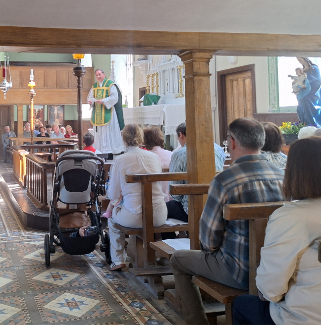 A Priest speaks to his congregation inside the Drumcree Church.