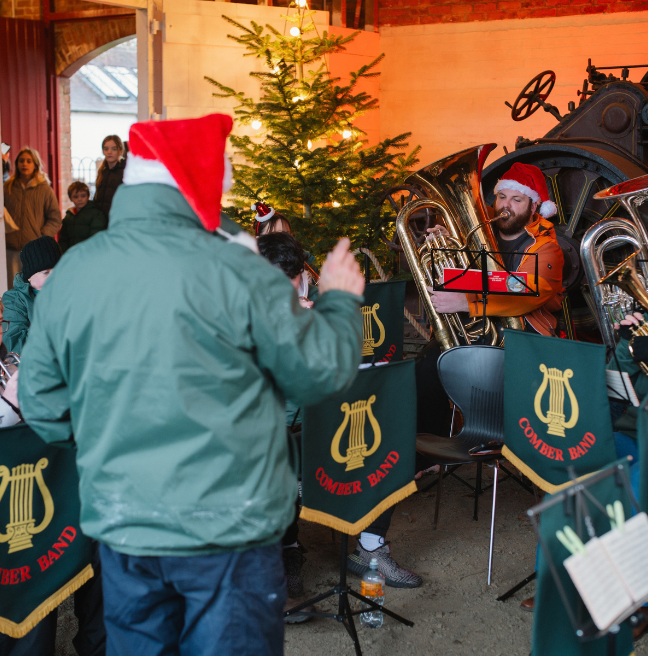 A man conduciting a brass band at christmas