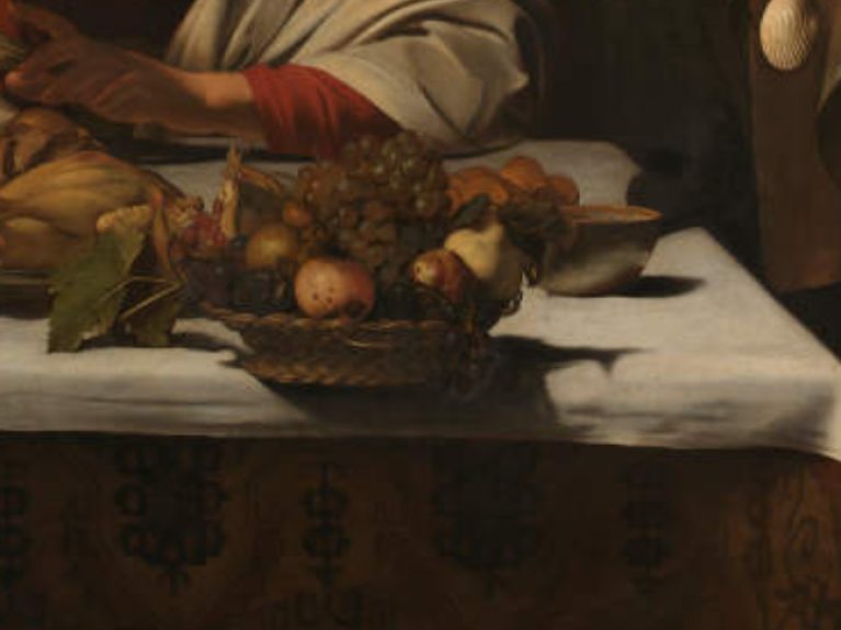A close up of a Caravaggio painting showing the fruit bowl on the edge of a table draped in white table cloth. 