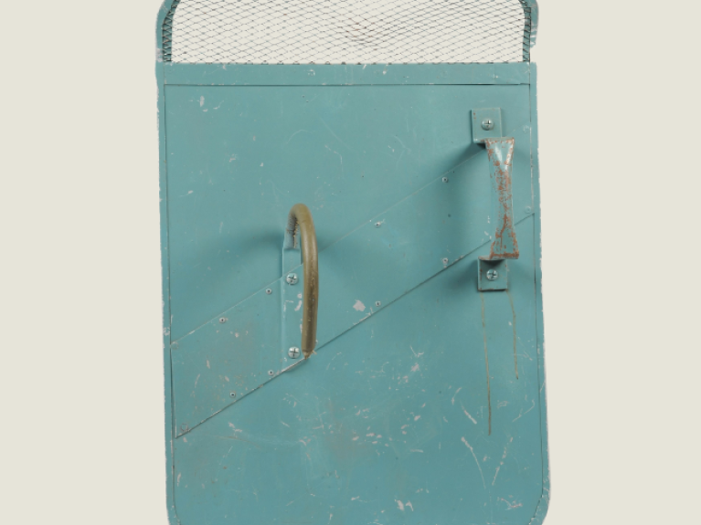 Blue rectangular riot shield with two handles and mesh section at the top