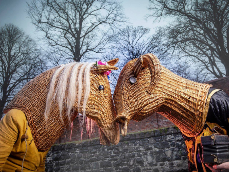 two people wearing wooden masks in the same of horse and goat heads, known as armagh rhymers