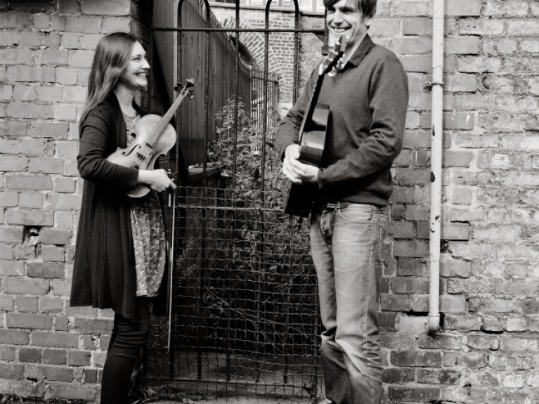 a black and white image of a woman and man holding string instruments, Zoe Conway and John McIntyre