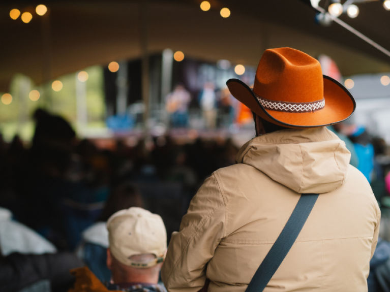 A man wearing a brown cowboy hat 