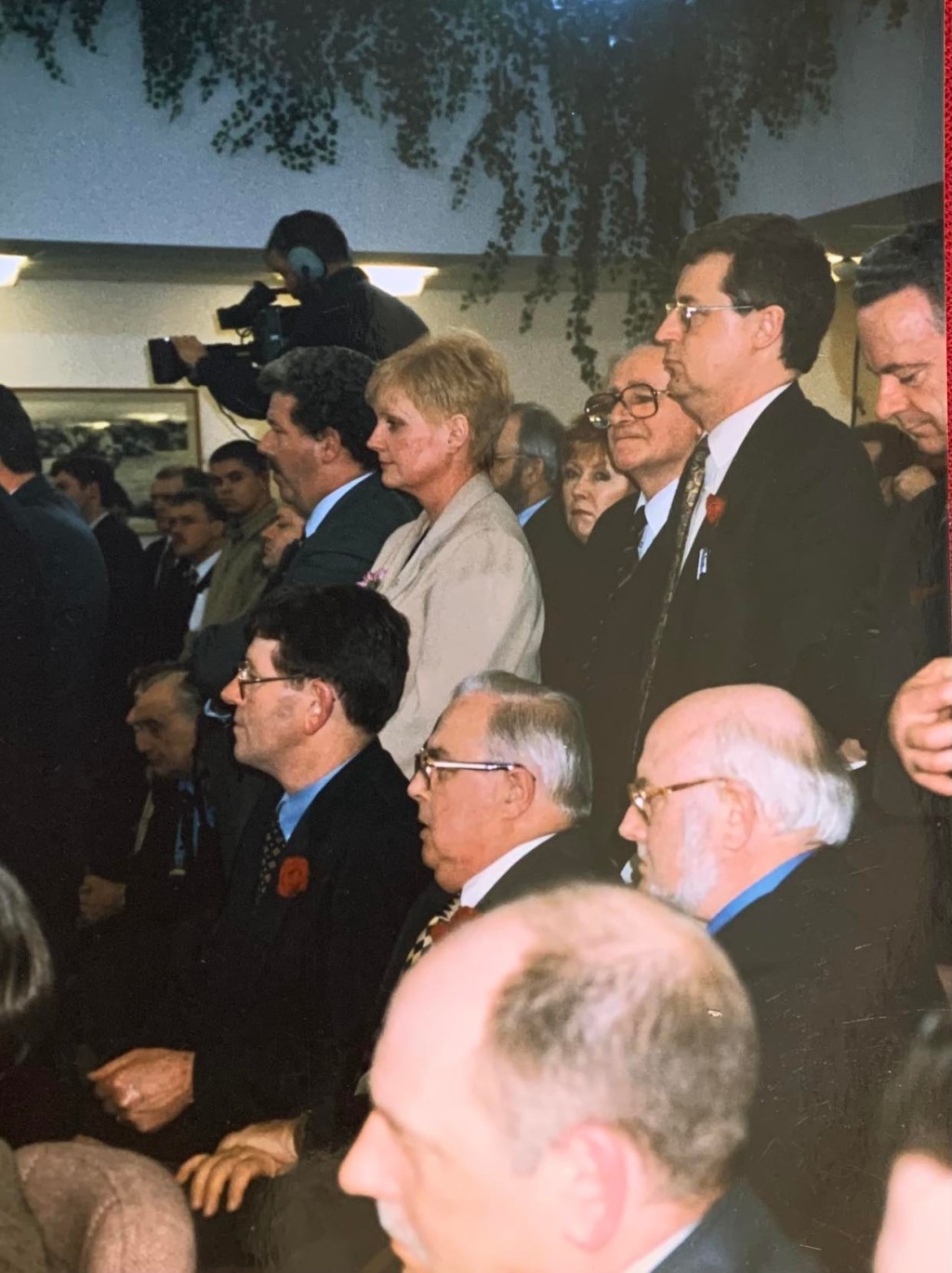 Photograph taken by Jane Morrice at the signing of the Belfast/Good Friday Agreement. One woman standing in the middle of a group of men.